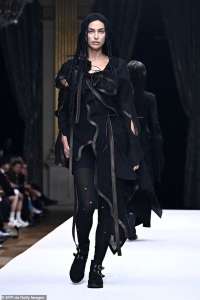 Irina Shayk s’assure que tous les regards sont rivés sur elle dans une robe noire originale et une capuche alors qu’elle défile pour Yohji Yamamoto lors de la Fashion Week de Paris.