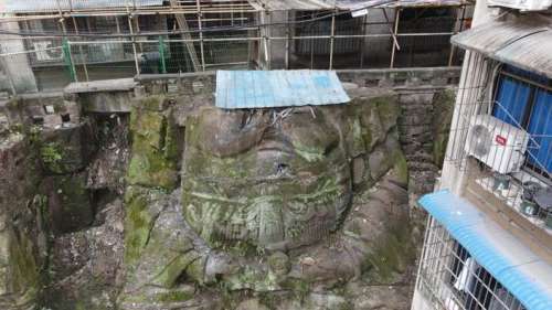 En Chine, une gigantesque statue décapitée refait surface au milieu des immeubles