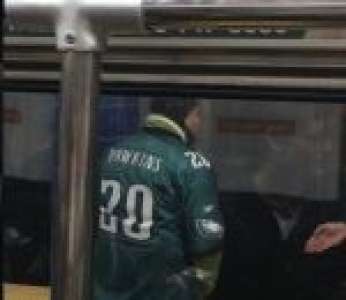 Un supporter des Eagles court à côté d'un métro et oublie de regarder devant lui